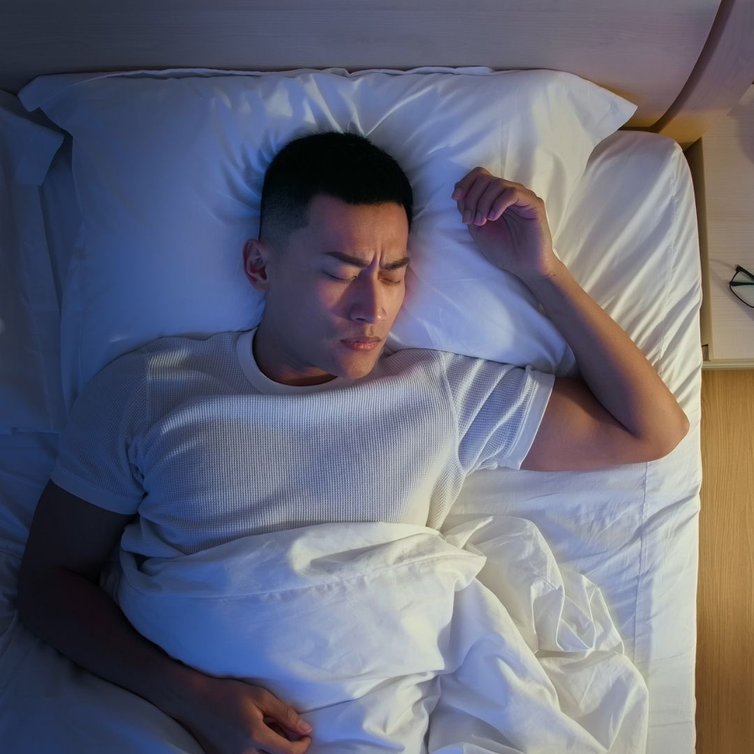 Person lays in bed, getting a good night's sleep
